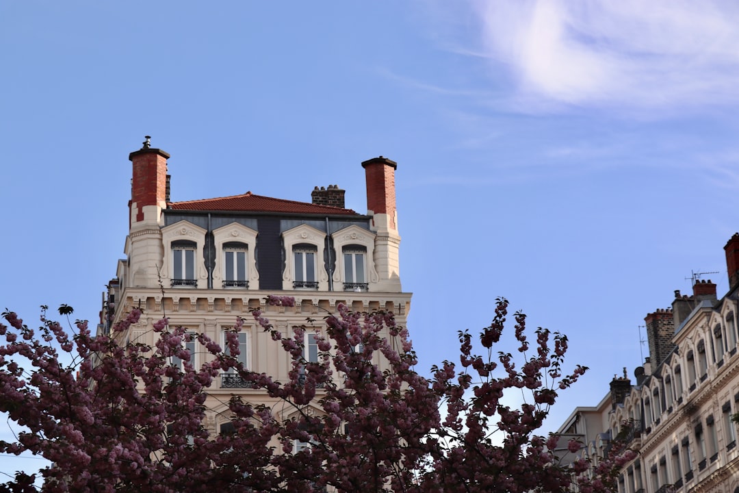 Building with chimneys against a blue sky.